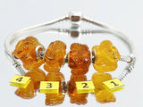 Cognac Amber Carved Snakes Charm Bead