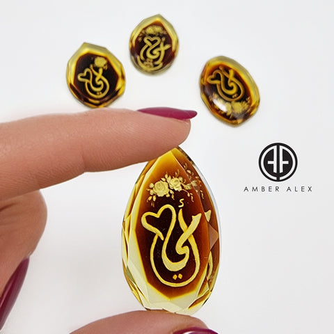 Two Tone Amber Engraved 'Mother' in Arabic Faceted Oval Shape Cabochons