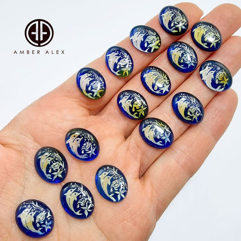 Blue Amber Engraved Dolphins Oval Shape Cabochons