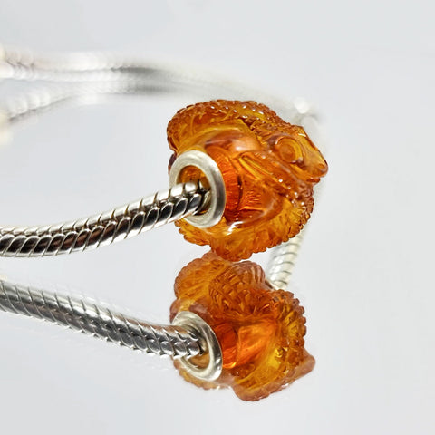 Cognac Amber Carved Snakes Charm Bead