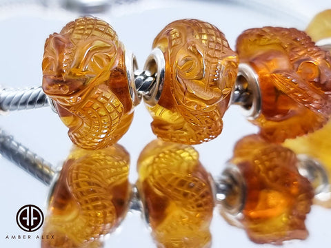 Cognac Amber Carved Snakes Charm Bead