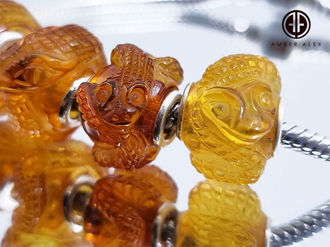 Cognac Amber Carved Snakes Charm Bead